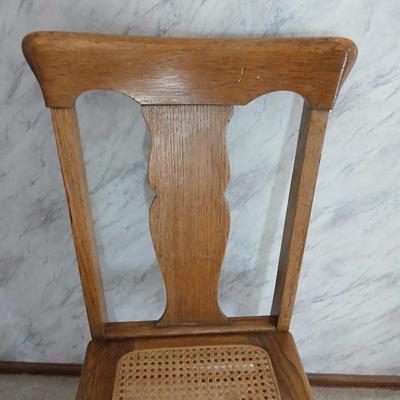 Vintage wicker seat dining room chair and an Afghan shawl