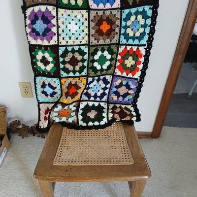 Vintage wicker seat dining room chair and an Afghan shawl