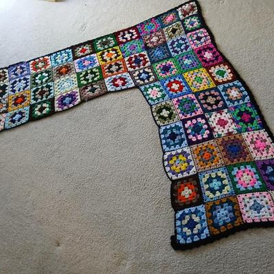 Vintage wicker seat dining room chair and an Afghan shawl