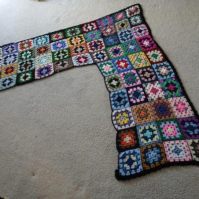 Vintage wicker seat dining room chair and an Afghan shawl