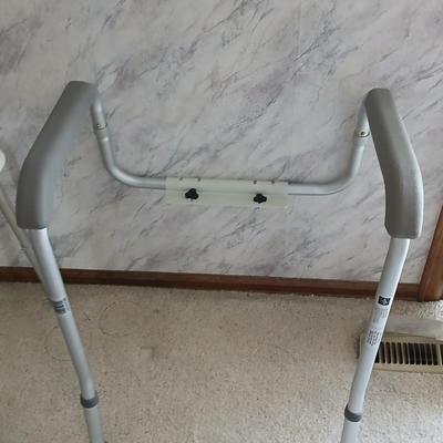 Medical assist shower chair and a toilet safety frame rail both with adjustable legs