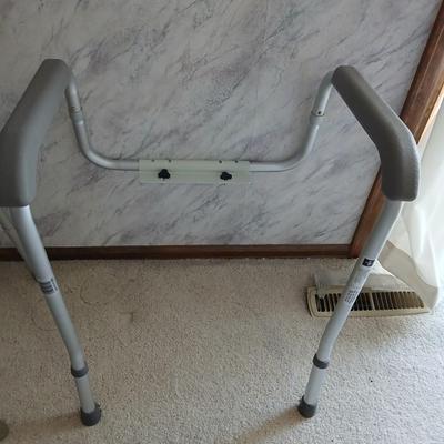 Medical assist shower chair and a toilet safety frame rail both with adjustable legs