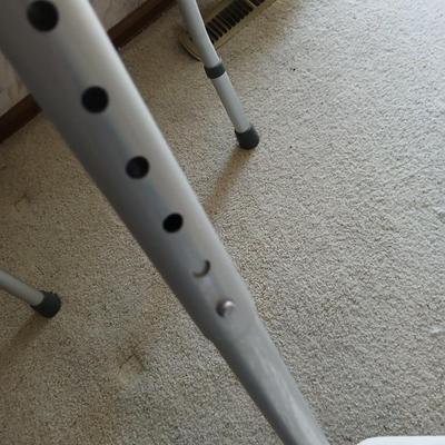 Medical assist shower chair and a toilet safety frame rail both with adjustable legs