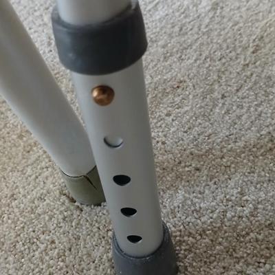 Medical assist shower chair and a toilet safety frame rail both with adjustable legs