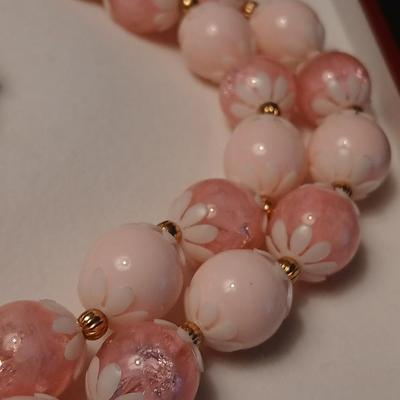 Two fashion necklaces with brooches and earrings