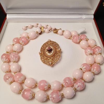 Two fashion necklaces with brooches and earrings