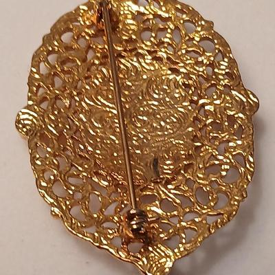 Two fashion necklaces with brooches and earrings