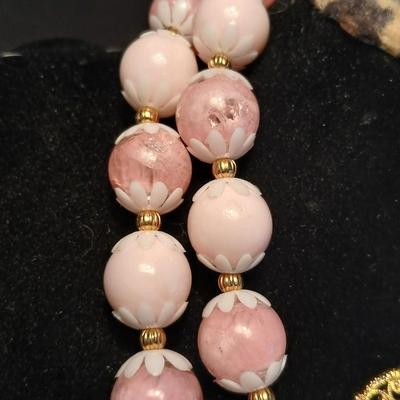 Two fashion necklaces with brooches and earrings