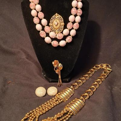 Two fashion necklaces with brooches and earrings