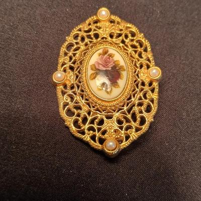 Two fashion necklaces with brooches and earrings