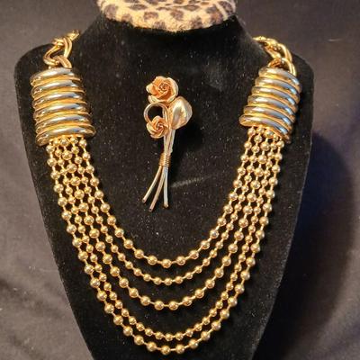 Two fashion necklaces with brooches and earrings