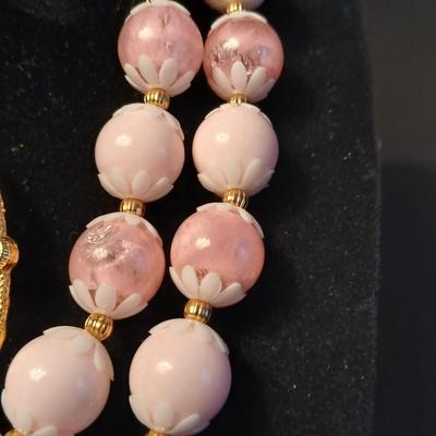 Two fashion necklaces with brooches and earrings