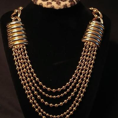 Two fashion necklaces with brooches and earrings