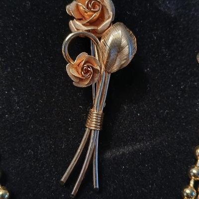 Two fashion necklaces with brooches and earrings