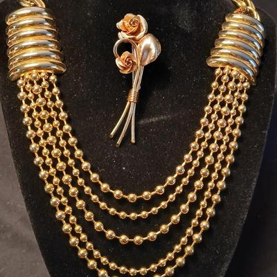 Two fashion necklaces with brooches and earrings