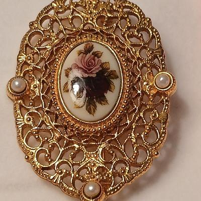 Two fashion necklaces with brooches and earrings