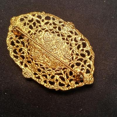 Two fashion necklaces with brooches and earrings