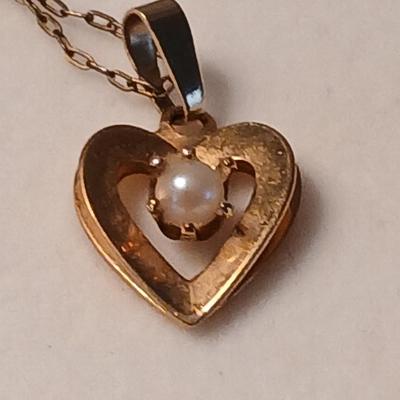 Heart pendant with pearl in the center and a vintage flower brooch