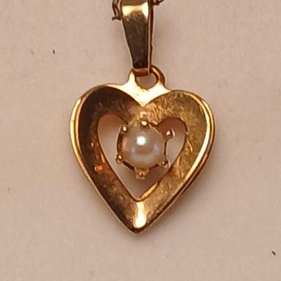Heart pendant with pearl in the center and a vintage flower brooch