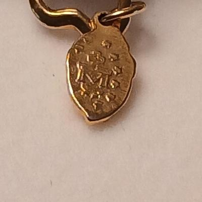 Heart pendant with pearl in the center and a vintage flower brooch