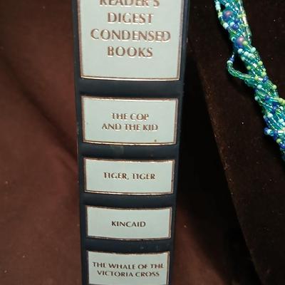 Beaded costume jewelry necklaces and earrings with faux book storage box