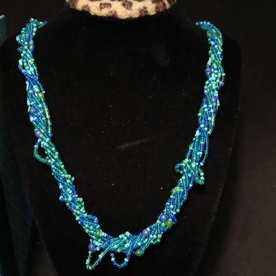 Beaded costume jewelry necklaces and earrings with faux book storage box