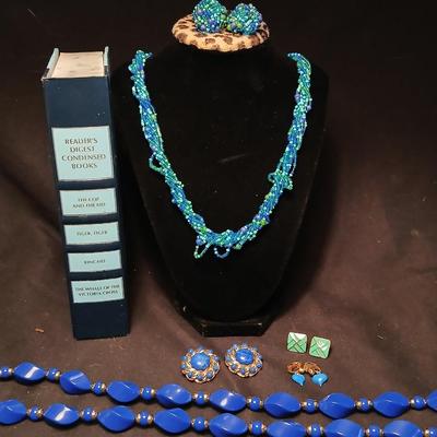 Beaded costume jewelry necklaces and earrings with faux book storage box