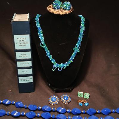 Beaded costume jewelry necklaces and earrings with faux book storage box