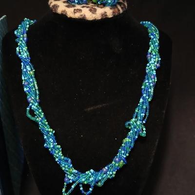 Beaded costume jewelry necklaces and earrings with faux book storage box