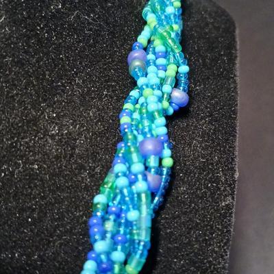 Beaded costume jewelry necklaces and earrings with faux book storage box