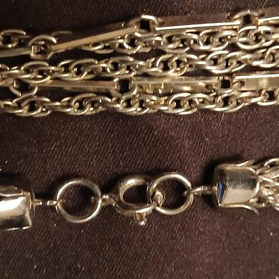 Long multi-chain necklace with an assortment of clip-on earrings