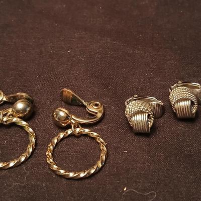 Long multi-chain necklace with an assortment of clip-on earrings