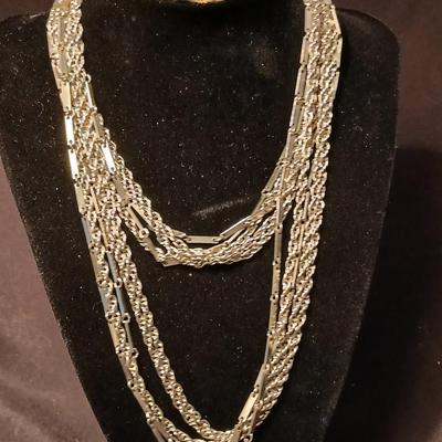 Long multi-chain necklace with an assortment of clip-on earrings