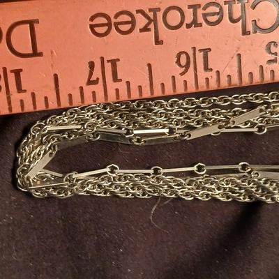 Long multi-chain necklace with an assortment of clip-on earrings