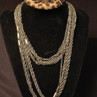 Long multi-chain necklace with an assortment of clip-on earrings