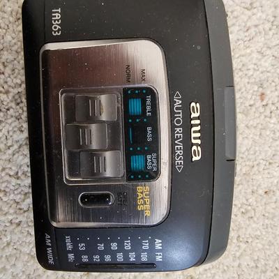 Aiwa Walkman with earphones and cassette tapes