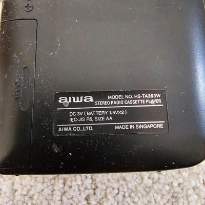 Aiwa Walkman with earphones and cassette tapes