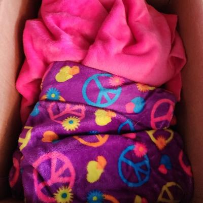 Box with two colorful blankets.