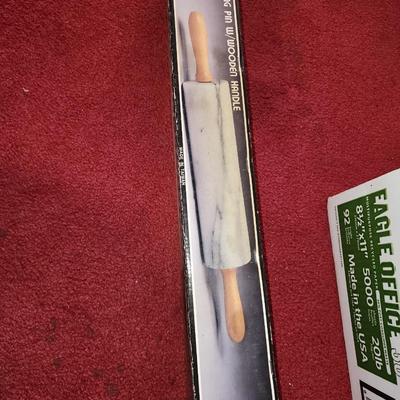 Marble rolling pin with wooden handles.