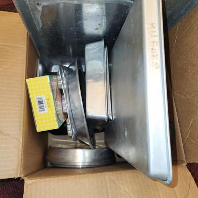 Box of baking sheets with shapes and more.