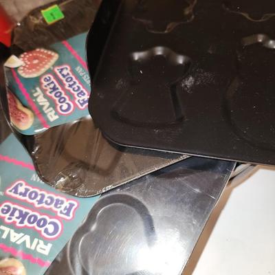 Box of baking sheets with shapes and more.