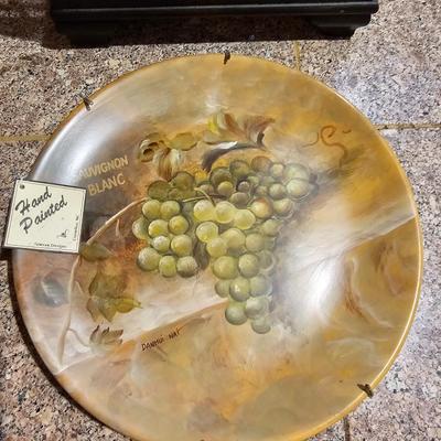 Nice wooden wine rack with wine themed plate and two stemmed glasses