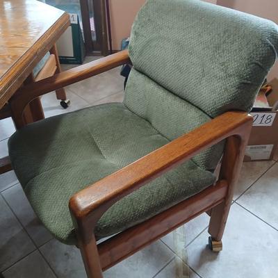 Oak Kitchen table with leaf and four upholstered chairs on casters
