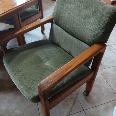 Oak Kitchen table with leaf and four upholstered chairs on casters