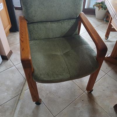 Oak Kitchen table with leaf and four upholstered chairs on casters