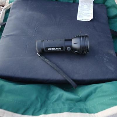 Folding camping chair with clean Igloo cooler on wheels