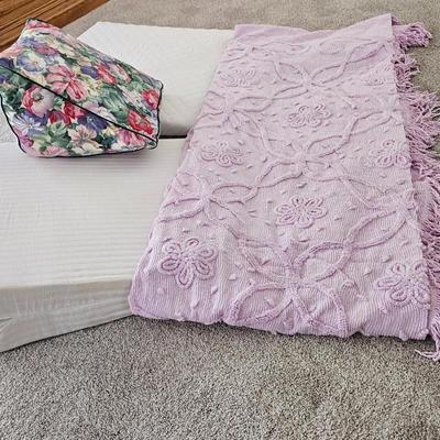 Three wedge pillows with a Chenille Bedspread