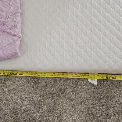 Three wedge pillows with a Chenille Bedspread