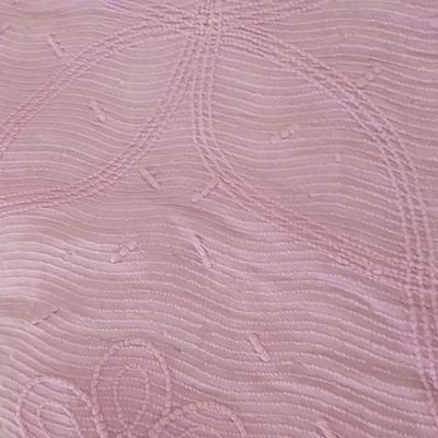 Three wedge pillows with a Chenille Bedspread