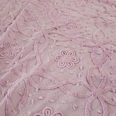 Three wedge pillows with a Chenille Bedspread